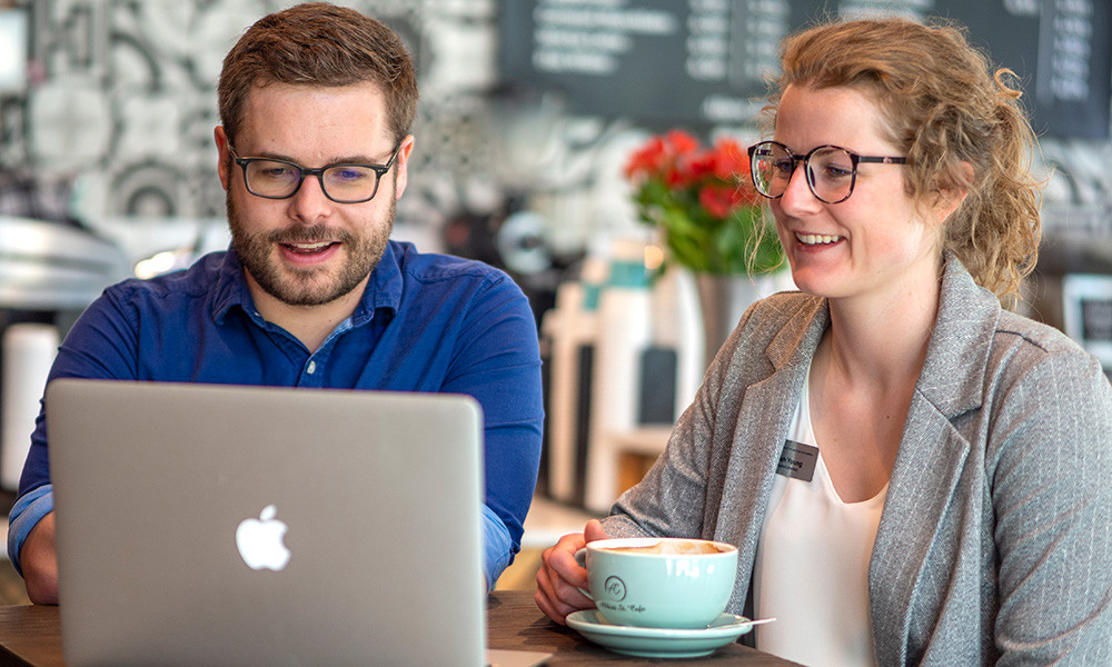 Brian Hayes and Hannah Young working together on a laptop